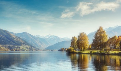 wonderlust view of highland lake With autumn trees under sunlight