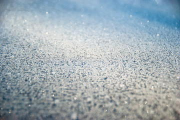 Obraz premium Winter drawing. Christmas background. Ice crystals on a glass.