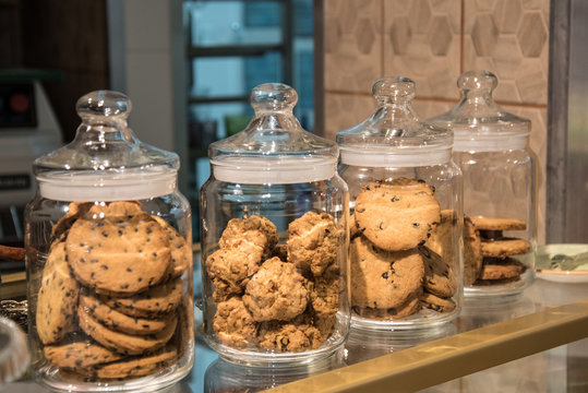 Sweets in the jar. Glass containers for food storage. Cookies in the cafe. Delicious food. The window of the restaurant.