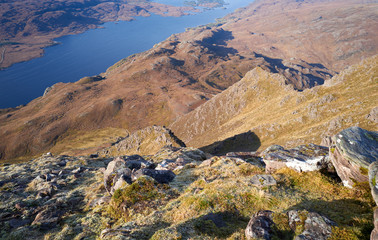 Looking down the steep rocky ridges from the summit of Slioch with Loch Maree far below in the Scottish Highlands.