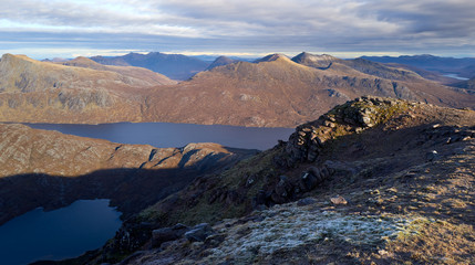 Views of Lochan Fada, Loch Garbhaig and the summit of Beinn Tarsuinn & Mullach Coire Mhic Fhearchair from the summit of Slioch in the Scottish Highlands in winter.