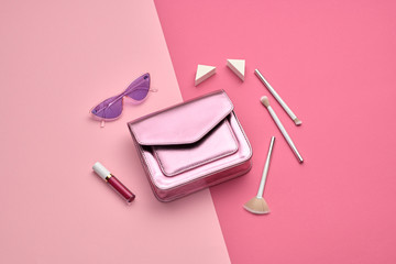 Woman Essentials cosmetic makeup pink Set. Fashion concept beauty product. Collection beauty accessories. Trendy Clutch, Brushes, lipstick. Coloful pink art Flat lay. Creative make up glamor style