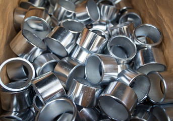 Steel sleeve. Details made lathe. Obtained on a lathe from steel and cast iron. Shallow depth of field. Parts stacked for further processing. Galvanized, coated part for anti-corrosion. Machined pipe