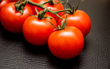 fresh tomatoes on black background