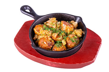 Fried sausage with onions and greens, served in cast iron pan