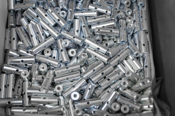 Steel sleeve. Details made lathe. Obtained on a lathe from steel and cast iron. Shallow depth of field. Parts stacked for further processing. Galvanized, coated part for anti-corrosion. Machined pipe