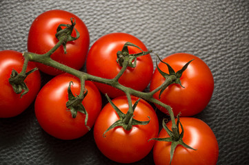 fresh tomatoes on black background