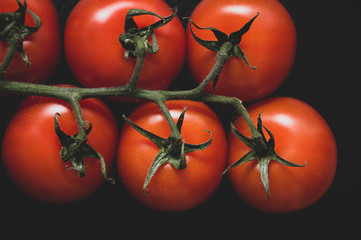 fresh tomatoes on black background