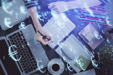 Financial chart drawn over hands taking notes background. Concept of research. Double exposure