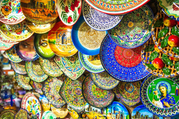 Fototapeta na wymiar Ceramic dishes at a market in Samarkand. Souvenir shop in Uzbekistan.