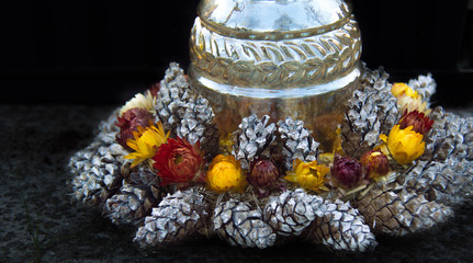 Monument and candles in the cemetery. All Saints Day in Poland. Funeral wreath. Needles. Funeral...
