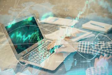 Double exposure of forex chart with man working on computer on background. Concept of market...