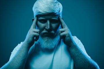 Concentrated man with albinism on blue background