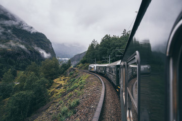 Reflection in train window of Flamsbana mountain railway in Flam, Norway