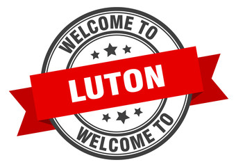 Luton stamp. welcome to Luton red sign