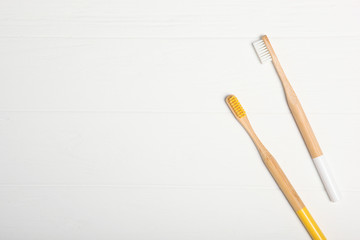 natural bamboo toothbrushes on a light background top view. Oral and dental care.