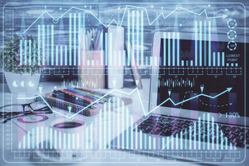 Financial graph colorful drawing and table with computer on background. Double exposure. Concept of international markets.