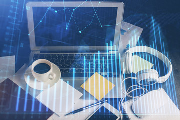 Financial chart drawing and table with computer on background. Multi exposure. Concept of...