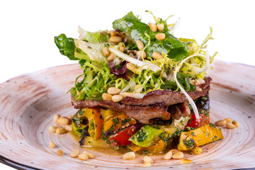 Warm salad with meat and vegetables with greens