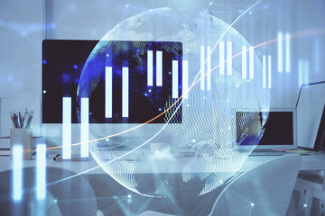Stock market graph on background with desk and personal computer. Multi exposure. Concept of financial analysis.