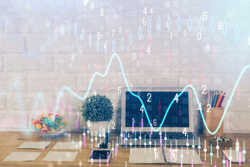 Financial chart drawing and table with computer on background. Multi exposure. Concept of international markets.