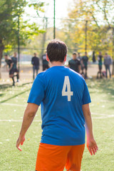 Fototapeta premium One soccer players performs an action play on a soccer field. All players wear unbranded clothes.