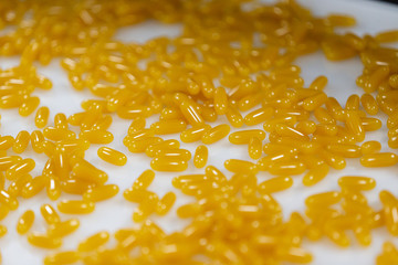 Yellow diet supplemental pills. Pharmaceutical manufactory. Drugstore. Medical research