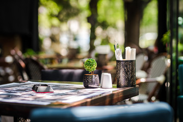Simple and elegant outdoor restaurant table set up on  green background
