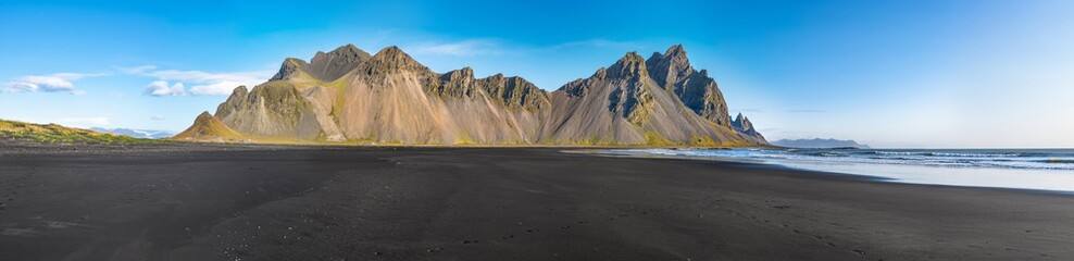 Epic view landscape of the black sand beach in Stokksnes on a sunny day. Vestrahorn mountain in the...