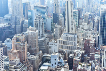 Fototapeta premium Aerial close up view of crowded buildings in New York City on a sunny day. Construction concept, crowded cities, and apartment rentals. NYC, USA