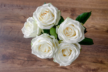 white rose flowers on a wooden background, vintage toned