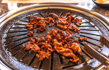 Spicy pork bulgogi (spicy marinated pork)is grilled in Korean restaurant.