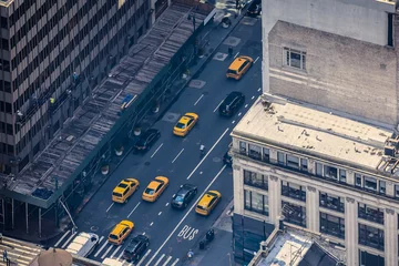 Papier Peint photo TAXI de new york Airstrip of New York City, with buildings and streets filled with the famous yellow taxis during the day. Concept of travel and transport. NYC, USA