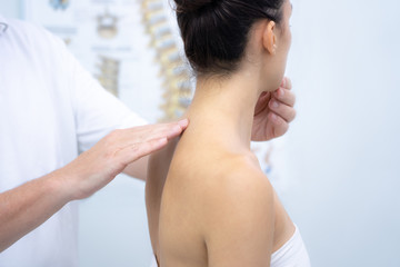 Doctor hand Physicist physical therapy treatment patient in the clinic. Orthopedic medical exam in...