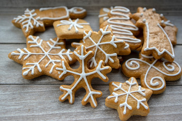 Painted traditional Christmas gingerbreads arranged on wood table in daylight, common czech tasty sweets