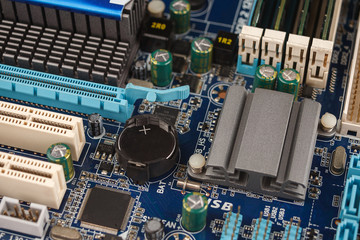 BIOS battery chips close-up macro on the motherboard of the computer, the firmware of the...