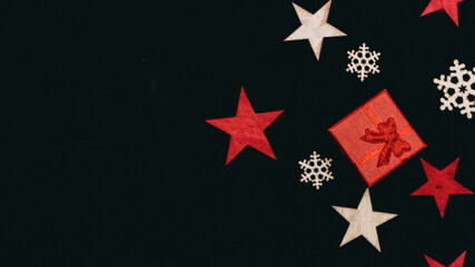 Fototapeta na wymiar handmade wooden stars and snowflakes isolated on black background, beautiful christmas decoration