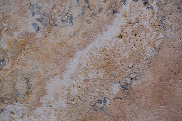 Wall of travertine with stone layers of different colors. Close up architecture macro photography. Creative wallpaper photography.