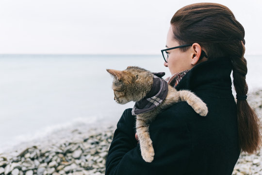 Woman With Cat In Bandana Standing On Coast By The Sea.