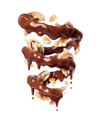 Chocolate splashes in spiral shape with crushed walnuts, isolated on a white background