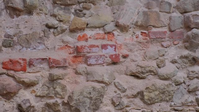 Old Stone broadwall of ancient fortress. Ancient Medieval castle wall surface.