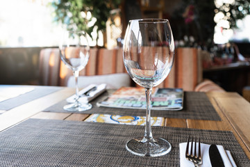 Wine glass in a restaurant. A table in the restaurant for guests.