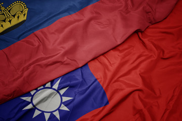 waving colorful flag of taiwan and national flag of liechtenstein.