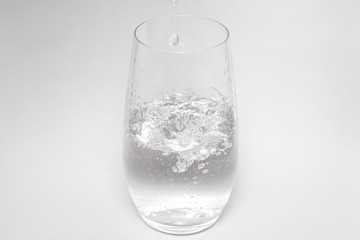 Glass of pure fresh water with white background and copyspace for text