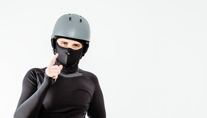 An athlete wearing a sweatshirt and helmet prepares for sport. The concept of playing sports, extreme sport. Putting on the necessary protective clothing.