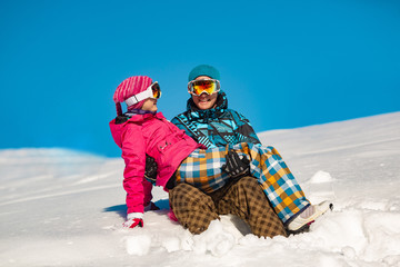 A pair of snowboarders on a slope