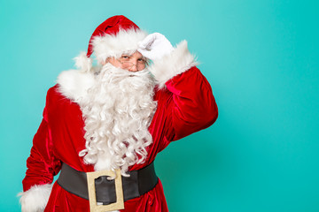 Santa Claus greeting people by touching his hat