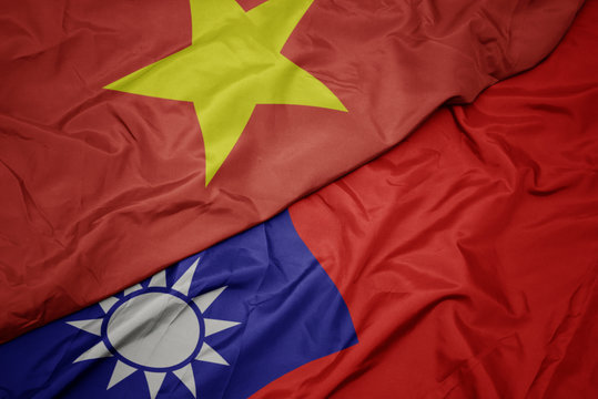 waving colorful flag of taiwan and national flag of vietnam.