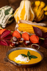 pumpkin soup on dark wood