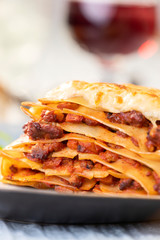 portion of lasagna with wine